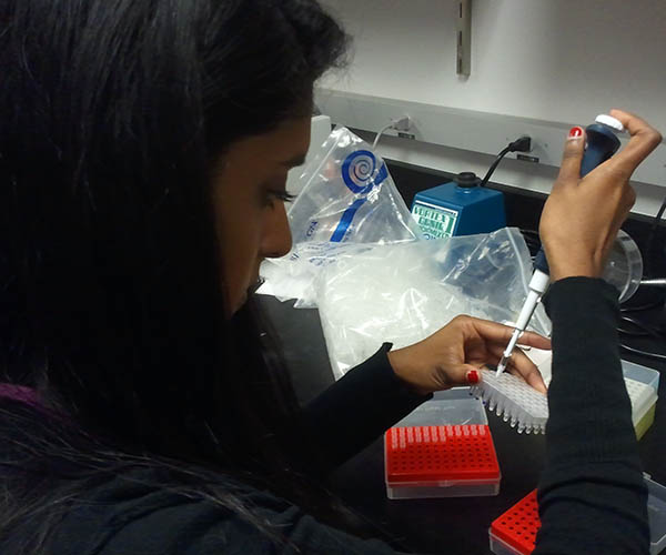 A female student performing an experiment