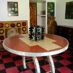 Metal starburst sculpture centerpiece on mosaic table in Pasaquan interior