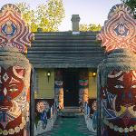 Pasaquan entrance pathway lined with totems leading to decorated buildings