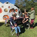 Women styling hair at a Pasaquan community event