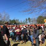 Large group of students gathered outdoors near Pasaquan's colorful decorated walls