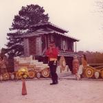 Eddie Owens Martin standing outside among the colorful structures at Pasaquan