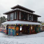 Pasaquan pagoda-style building covered in snow with painted geometric panels
