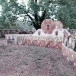 Historic 1977 photo of painted concrete walls with sculpted face medallions and spiral patterns