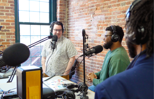Broadcast students in a studio talking into microphones