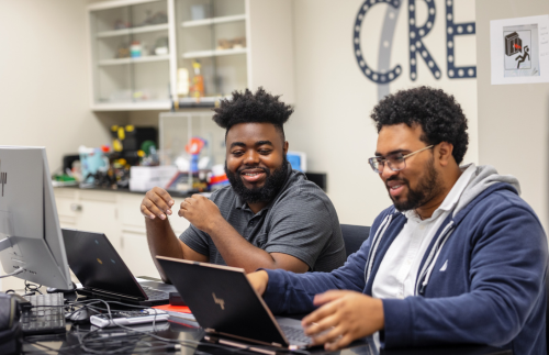 Two students at computers working