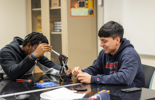 Two students working on a robotics project