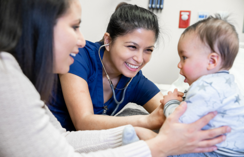 A nurse examining a baby