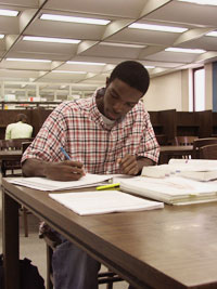 boy doing work in the library