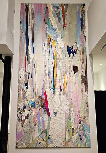 a canvas of artwork hanging on a wall with several color lines on it