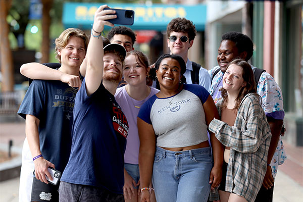 several students standing together posing for a selfie