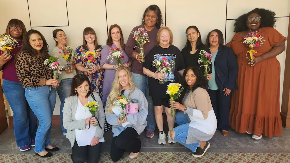 group of ladies holding flowers