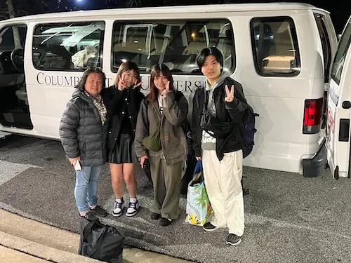 Group of international students posing for the camera as they arrive in the US
