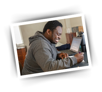 a man sitting at a desk writing on paper