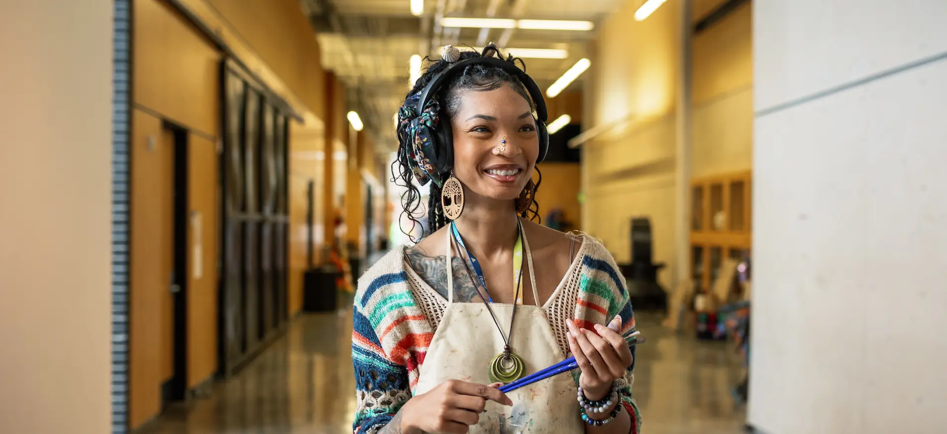 Art student holding paint brushes