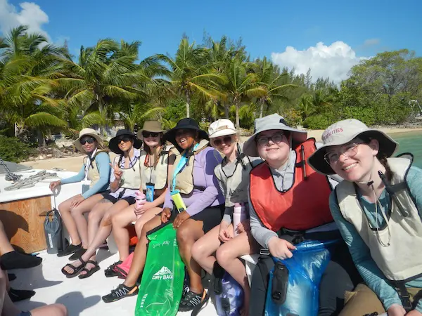 group of students traveling abroad sitting on a boat