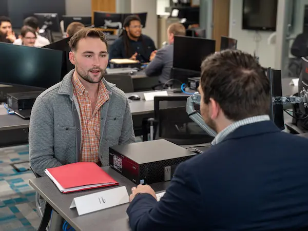 Business students doing mock interviews