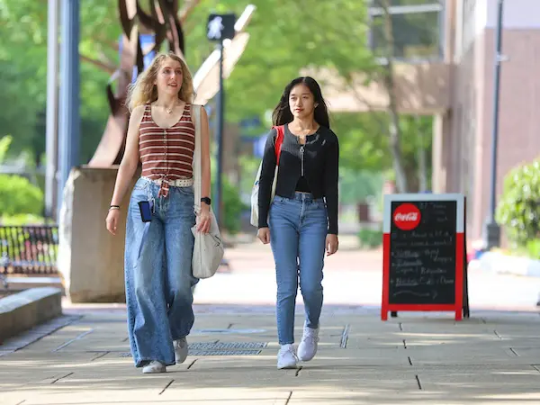 two female students walking down the sidewalk at RiverPark campus