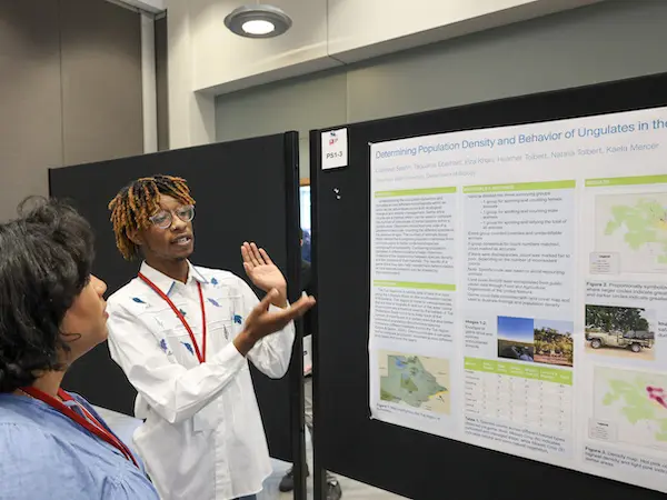 a male student discussing his data with a woman