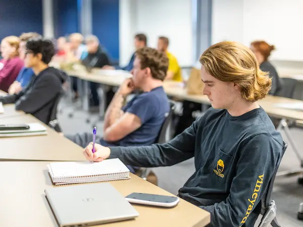 students sitting in a classroom at tables