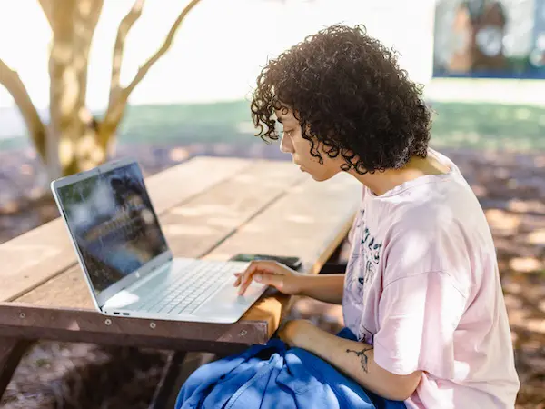 A student sitting at her laptop working