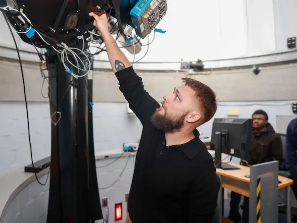a student working with a large telescope