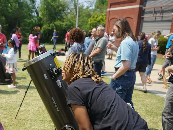 people looking through telescopes
