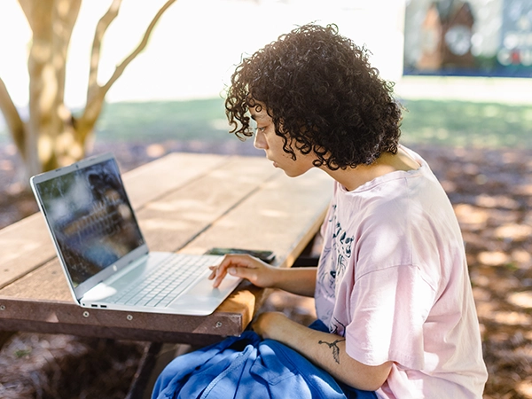 A student studying on her personal laptop.