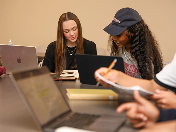 Two students study together in the CSU library.