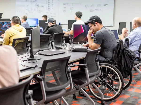 Students in a computer science classroom learning about Information Technology