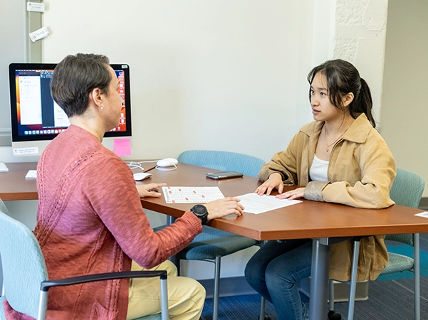 A student talking with an academic coach about her studies.