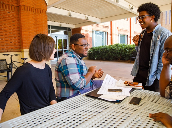 A group of students laughing together as they study.