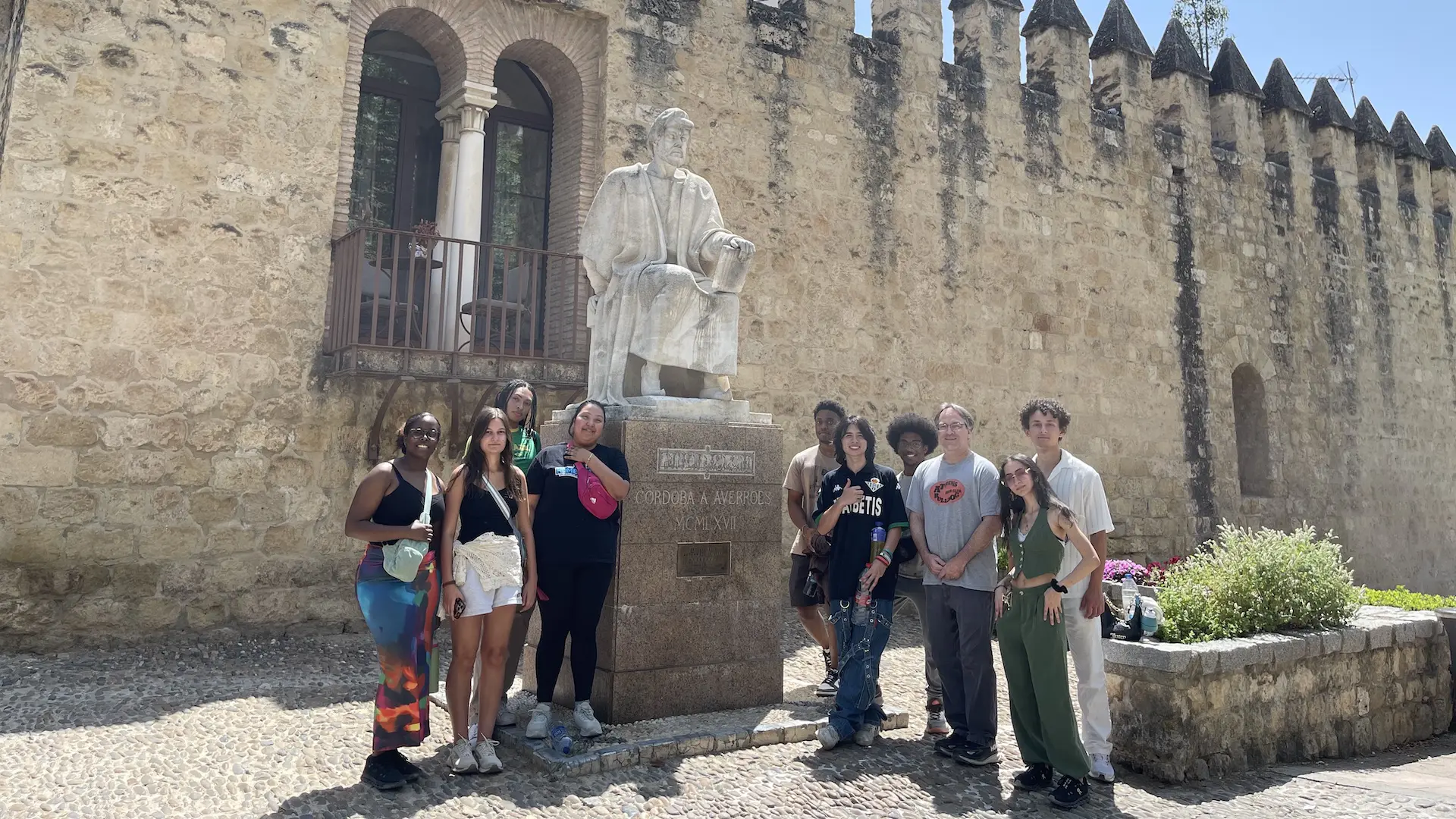 students in another country standing by a statue
