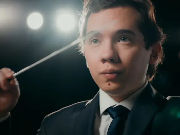 A male music student conducting