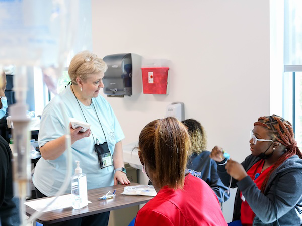 Professor interacting with nursing students
