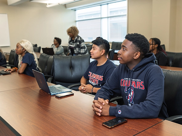 A group of students paying close attention to their lesson in a classroom.