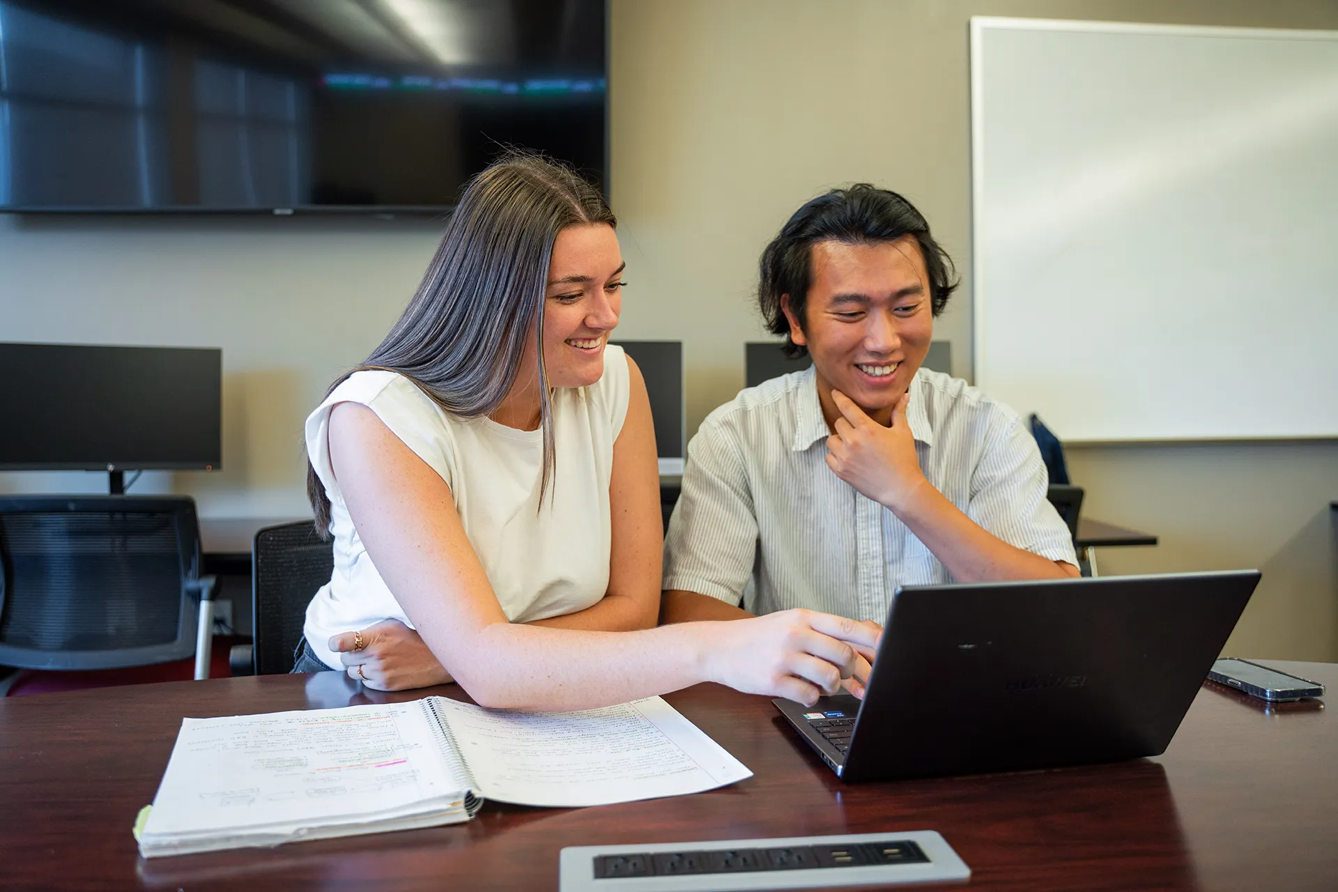 two students working together at a table