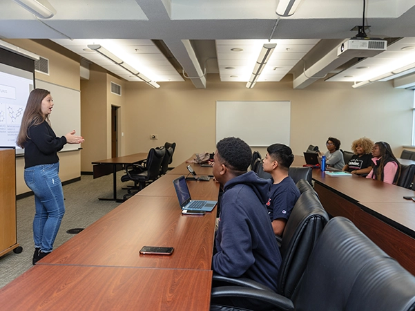 A classroom full of students learning about public health.