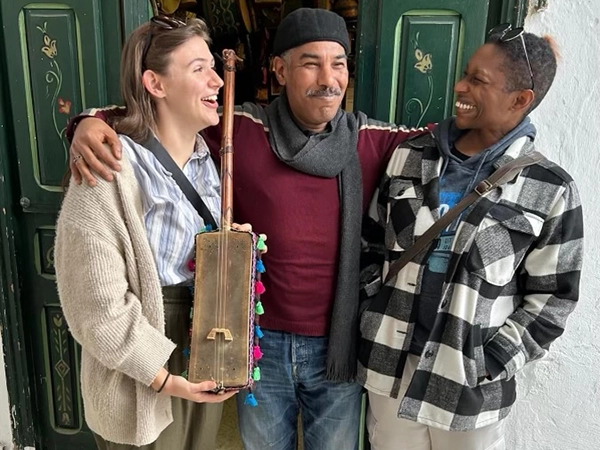 Spanish students studying abroad posing with a local guatamalan man.
