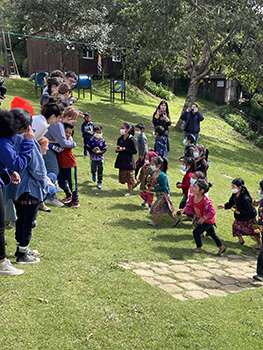 several students running around on a hill