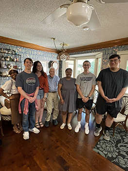 several people standing and posing for the camera