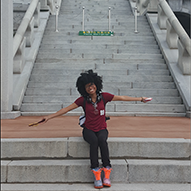 Aliyah Anglin smiling on outdoor steps