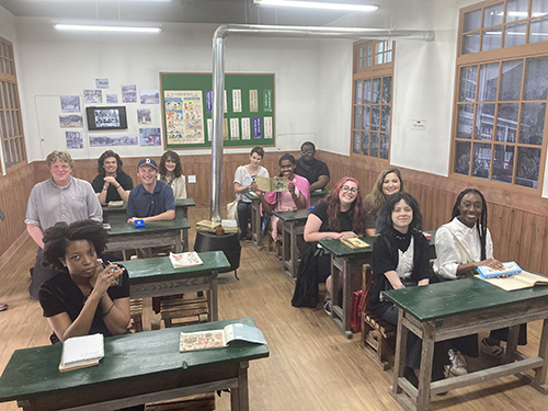 several students sitting at desks in a classroom