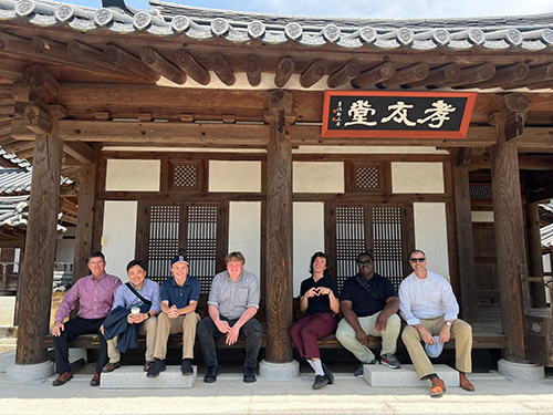 several people sitting on a building's porch