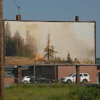A large billboard of a forest fire 