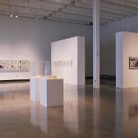 An empty art gallery, white walls, polished concrete floors 