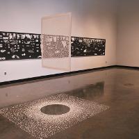 A clear rectangle that looks like it's floating (as an exhibit), other murals on the background walls 