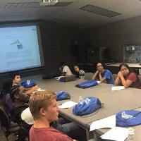 several students around a conference table