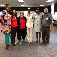 a group of older adults standing together for a group photo