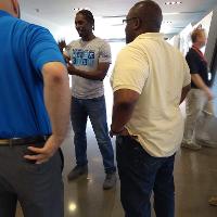 a man explaining something to a group of students